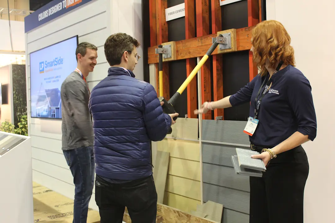 people at ibs testing smartside with a hammer drop