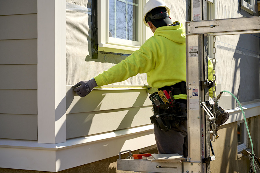 image of installer measuring siding
