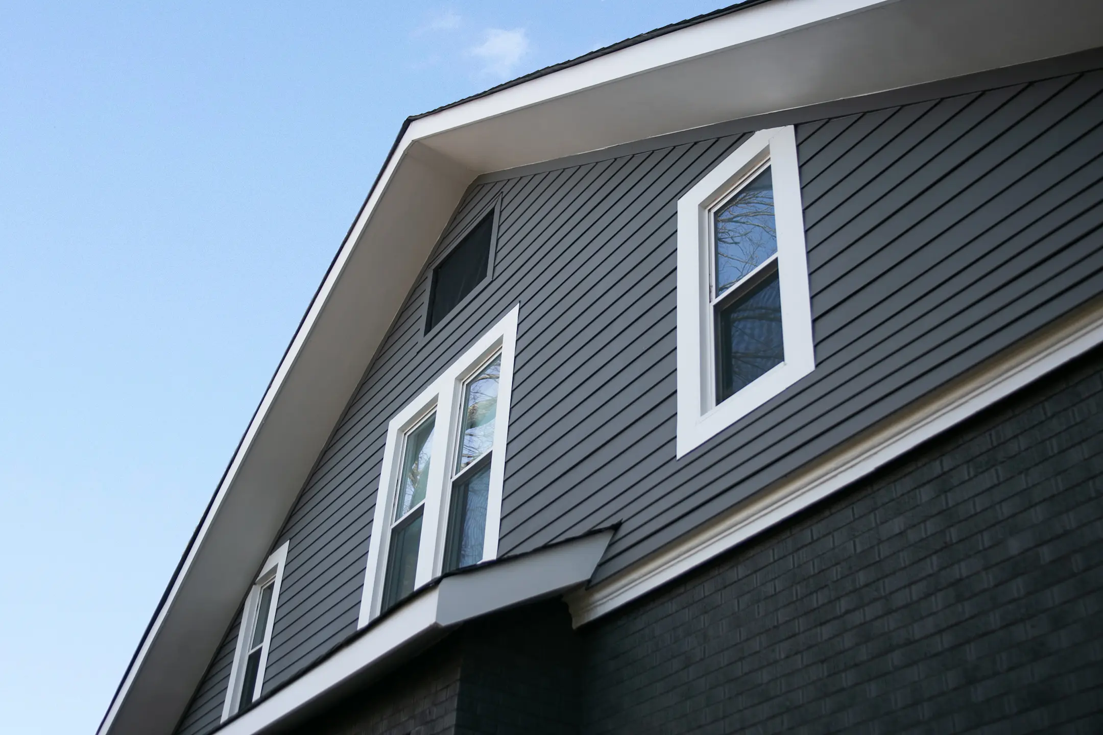 house with brick and black lap siding