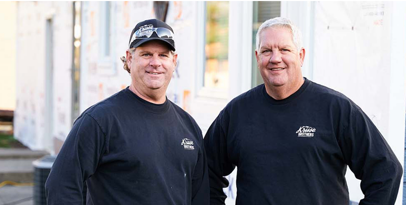 The Kruse Brothers standing next to each other and smiling at the camera
