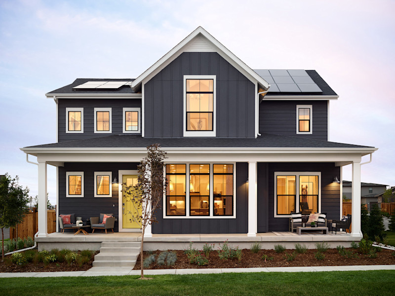Image of a gray home with a yellow front door