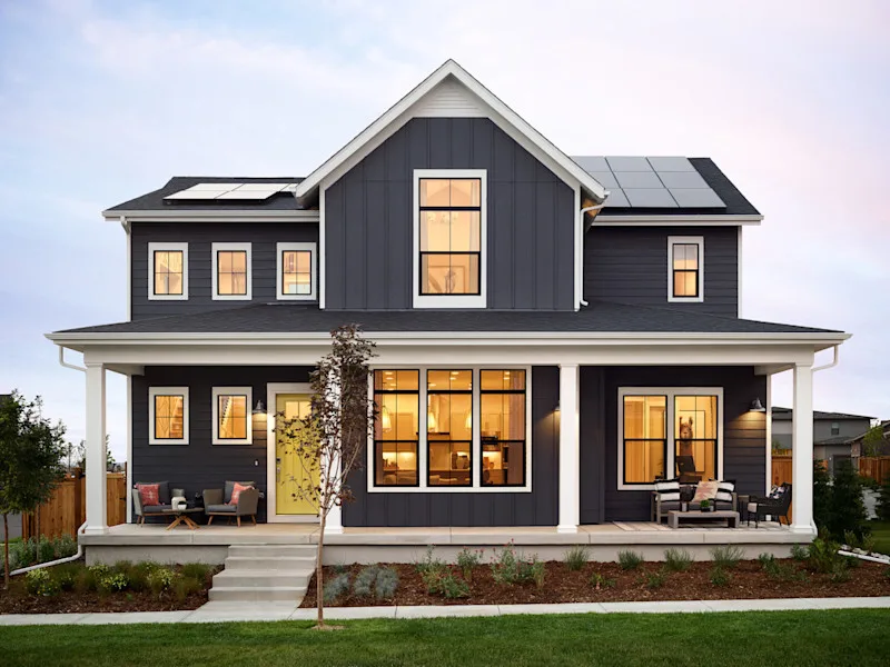 Image of a gray home with a yellow front door