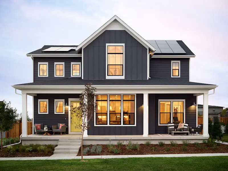 Image of a gray home with a yellow front door