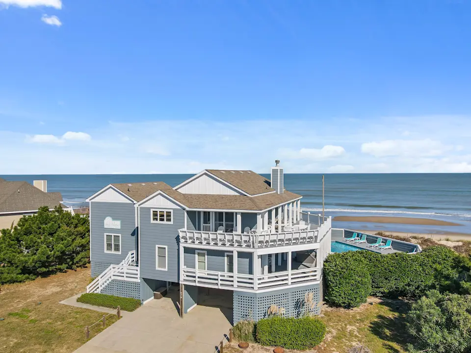 coastal capsule image blue house on the water