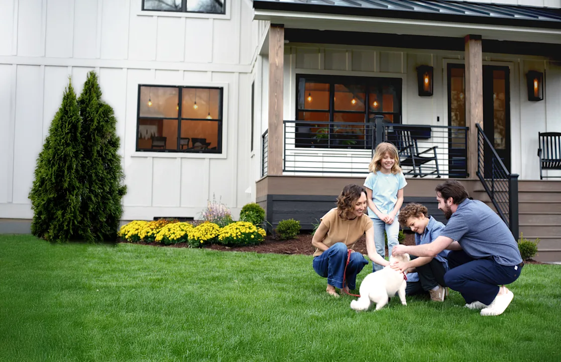 Image of a family in front of their home