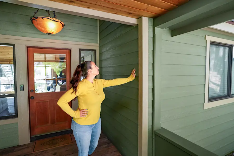 Image of homeowner looking at her home