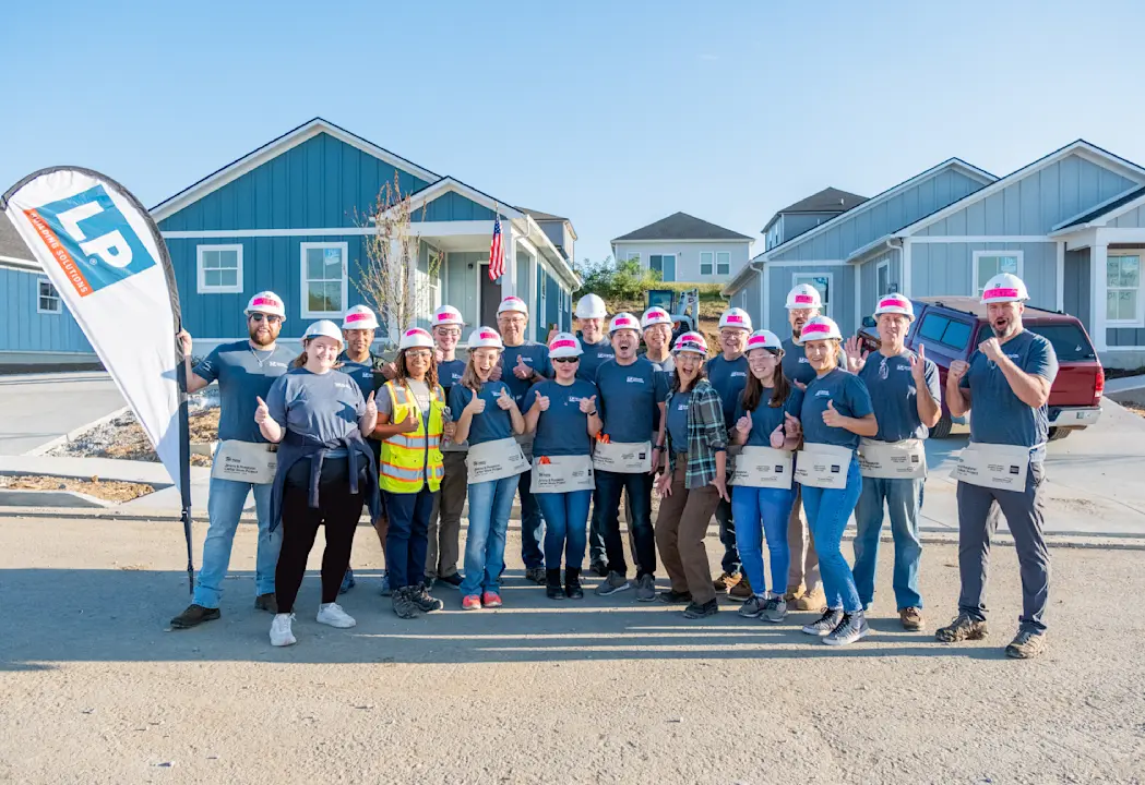 group of lp employees with a flag