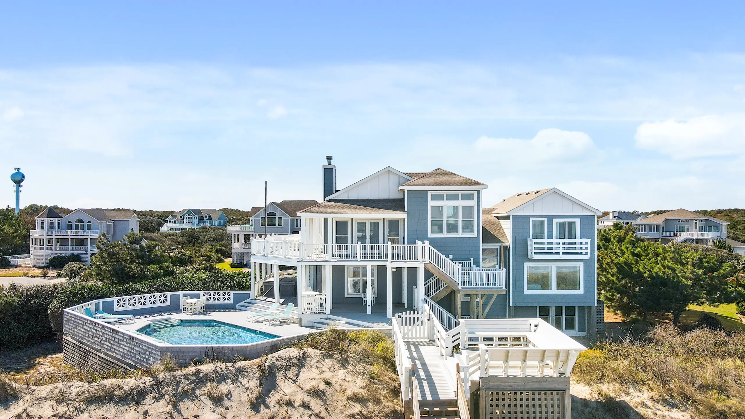 Image of a blue coastal home on the beach