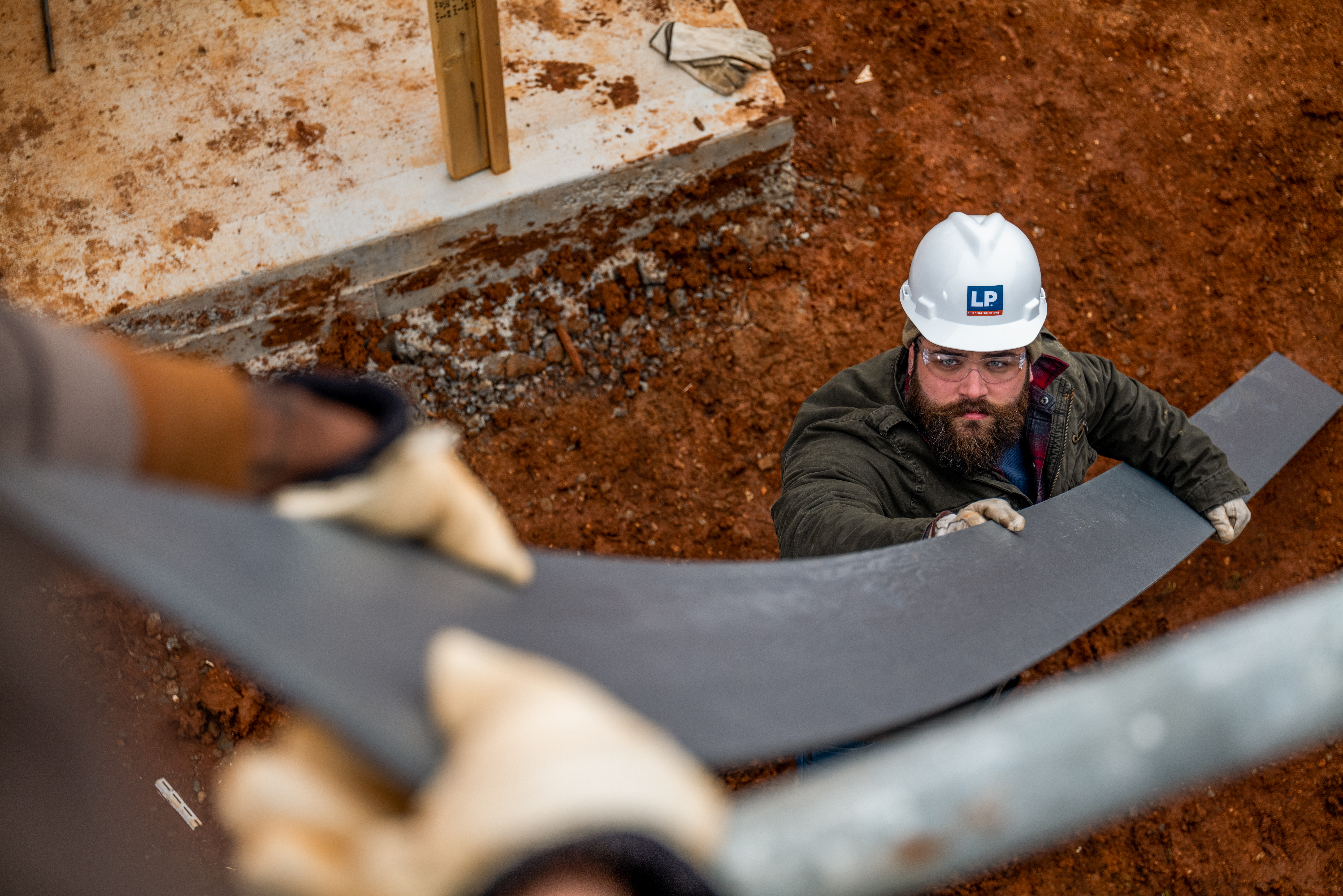Image of a builder holding siding