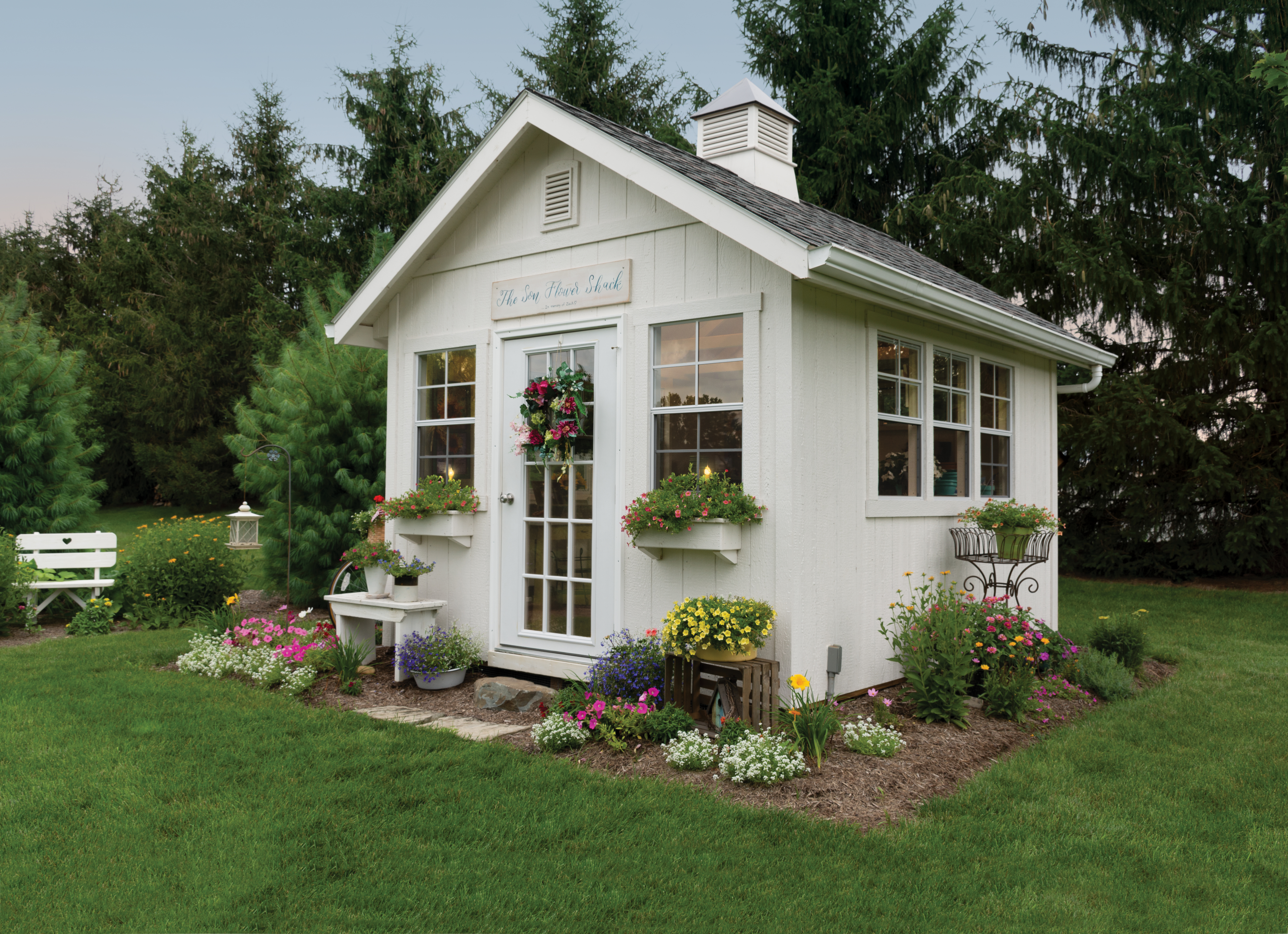 a white shed in a backyard