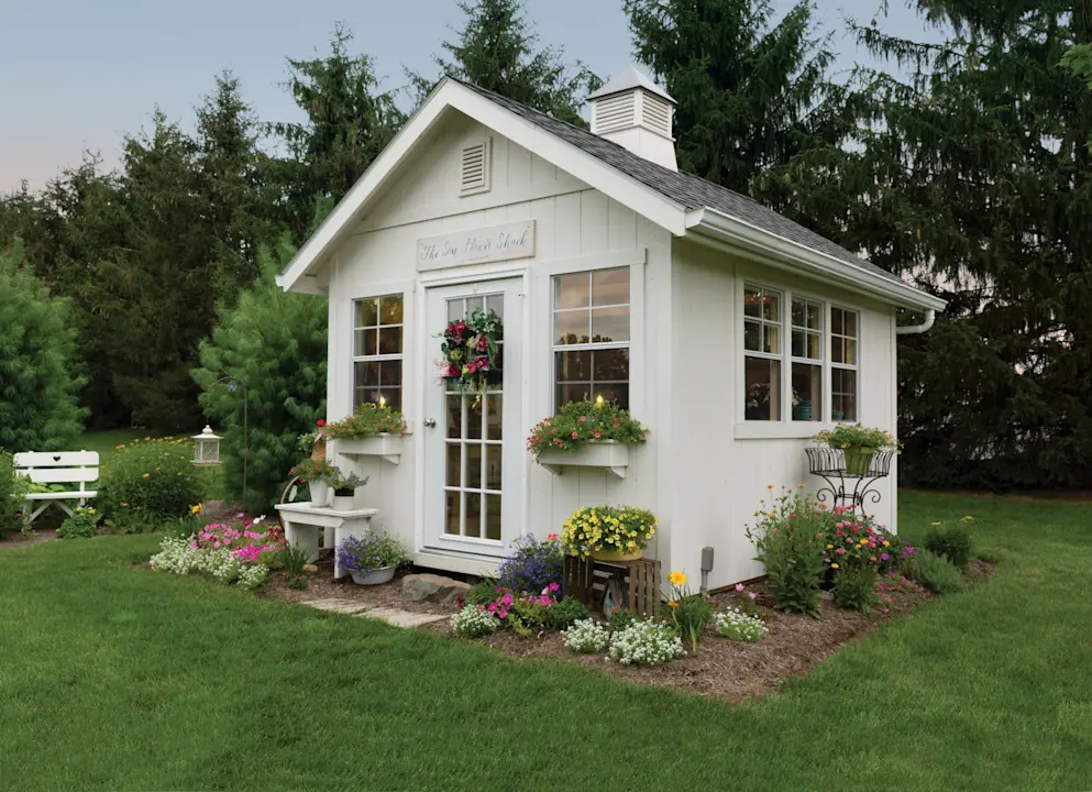 a white shed in a backyard