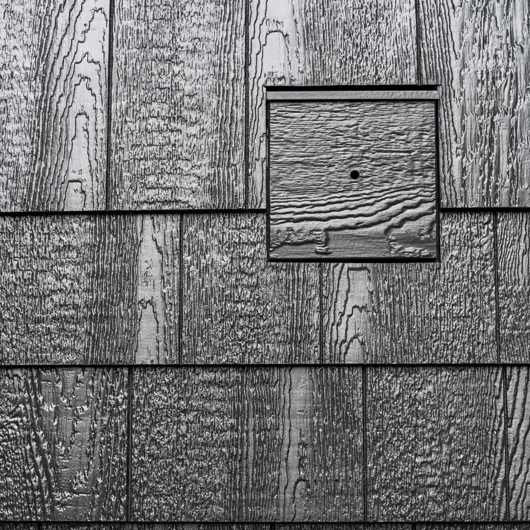 black cedar texture j block installed on a house