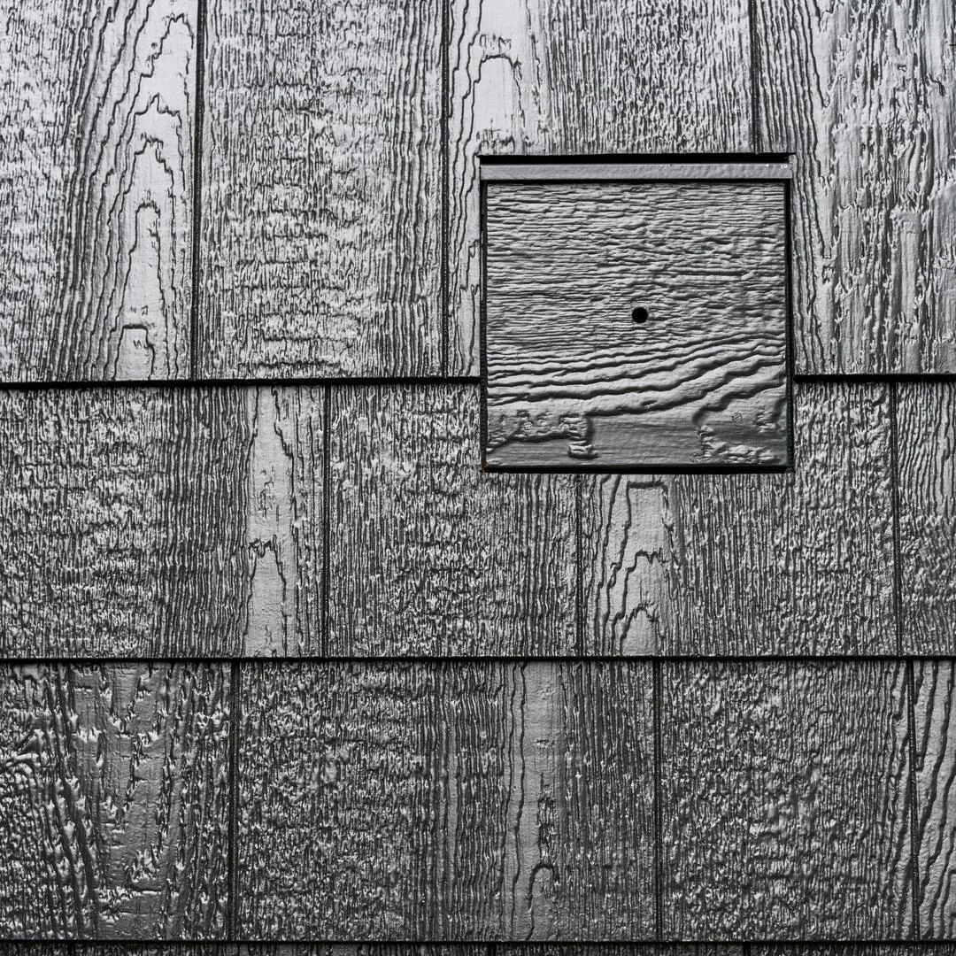 black cedar texture j block installed on a house
