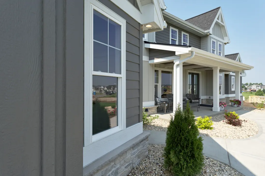 house with green vertical and lap siding