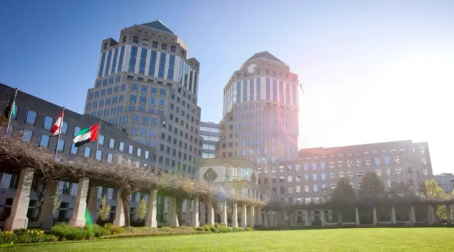 Building with 2 towers and flags