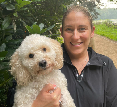 Qualified flea and worm expert, Sarah with her cockerpoo, Coco smiling for a picture