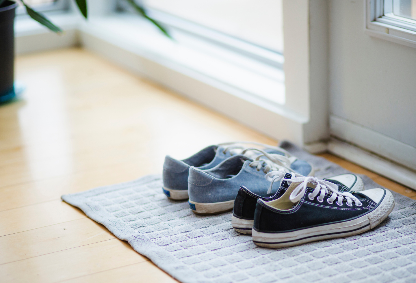 Canvas shoes on doormat near doorway