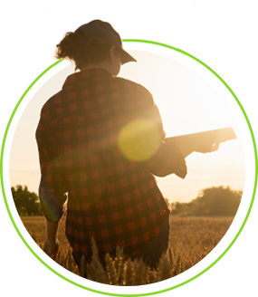 A farmer in a field with a tablet