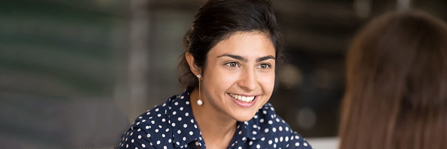 Person smiling at another person who's facing them