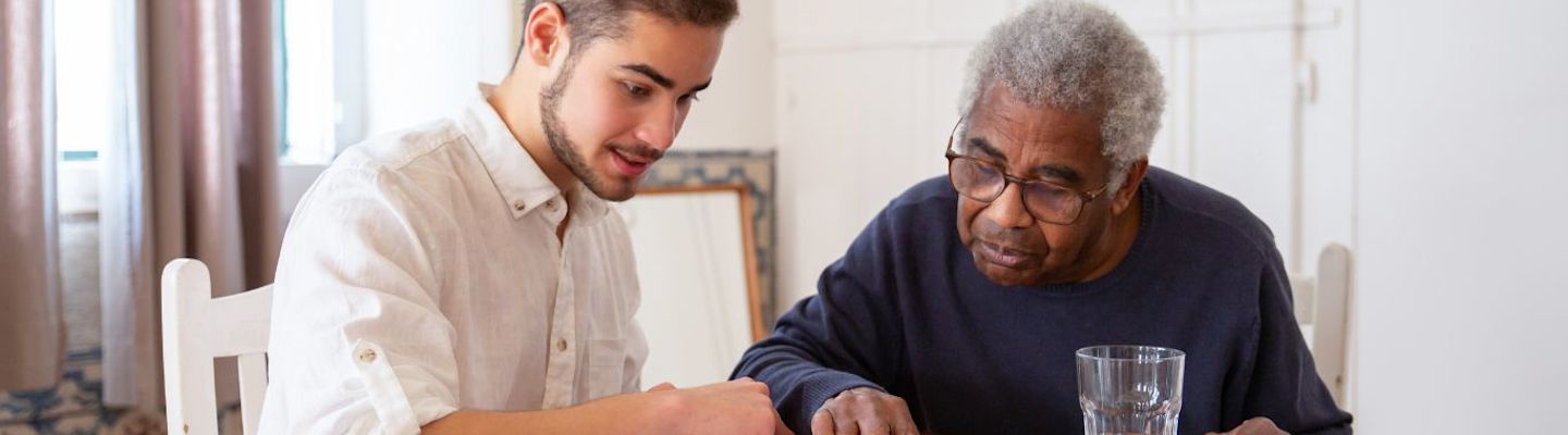 A student helping an aged man