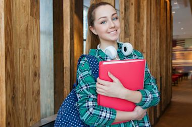 woman wearing glasses in work suit smiling at camera