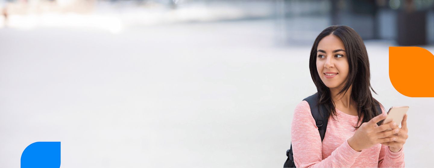IDP student smiling with books in her hand, representing international education opportunities