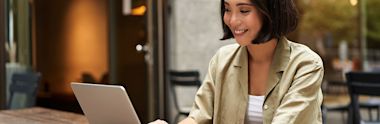 woman smiling a laptop