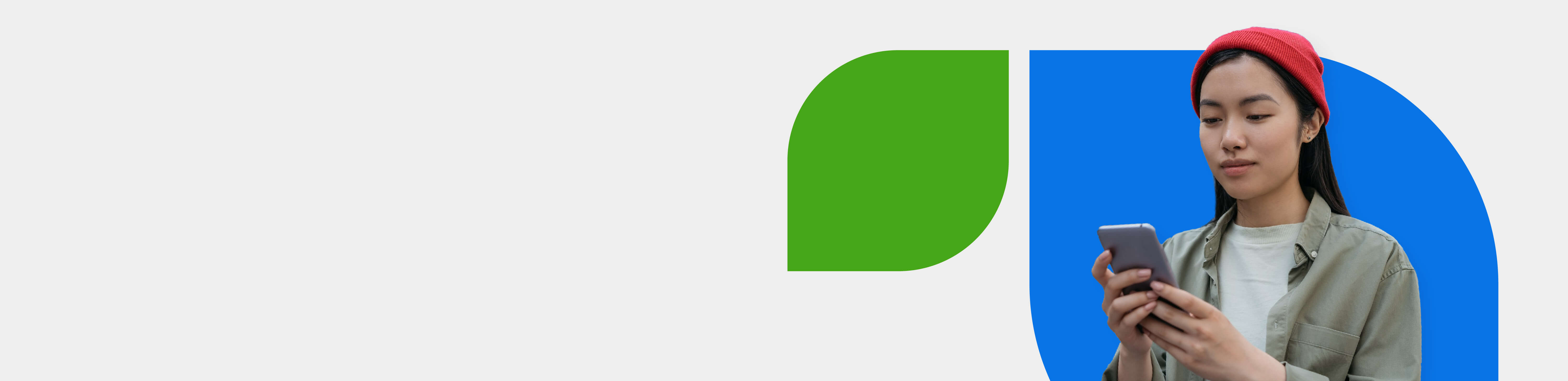  Person wearing red beanie and beige jacket looking at smartphone against blue and green geometric background