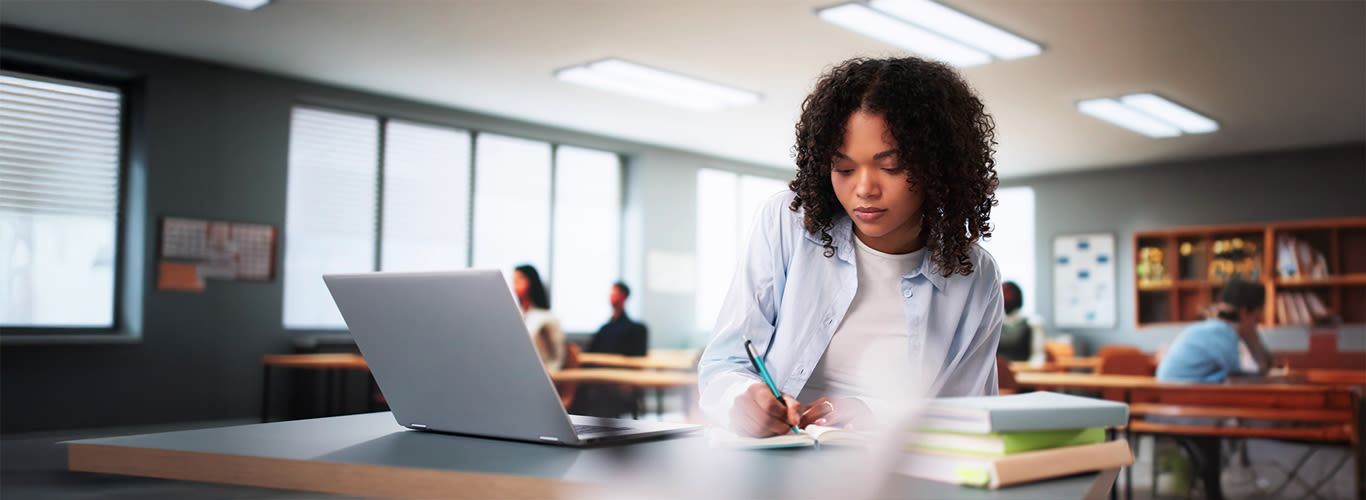 Student in classroom using a laptop