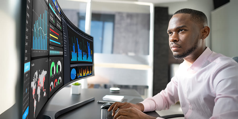 A person looking at a large monitor showing analytics