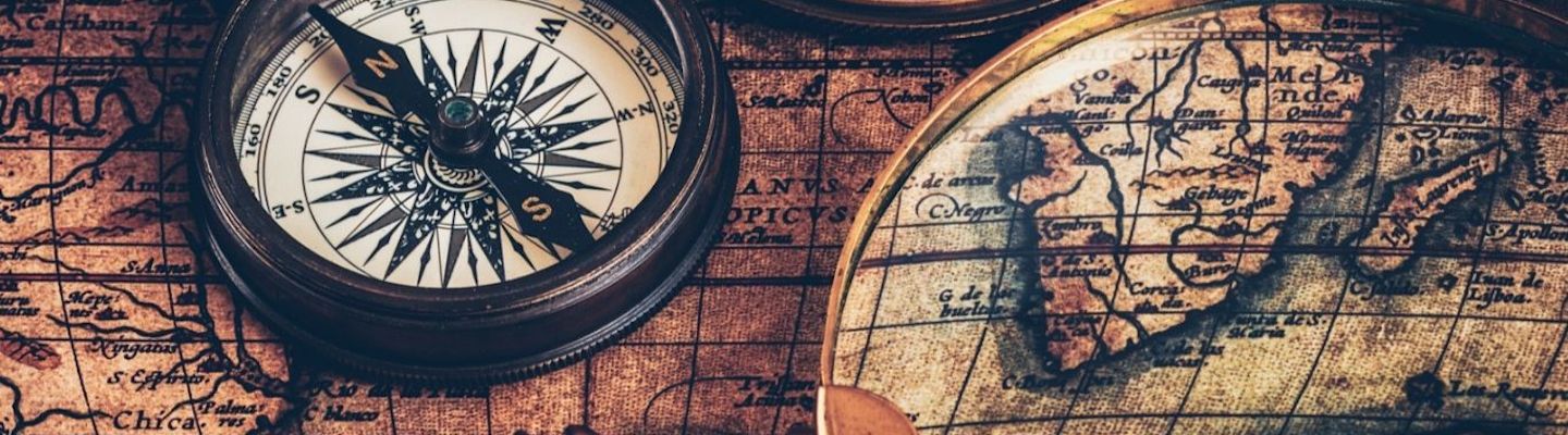 A picture depicting an ancient Compass and Maps'