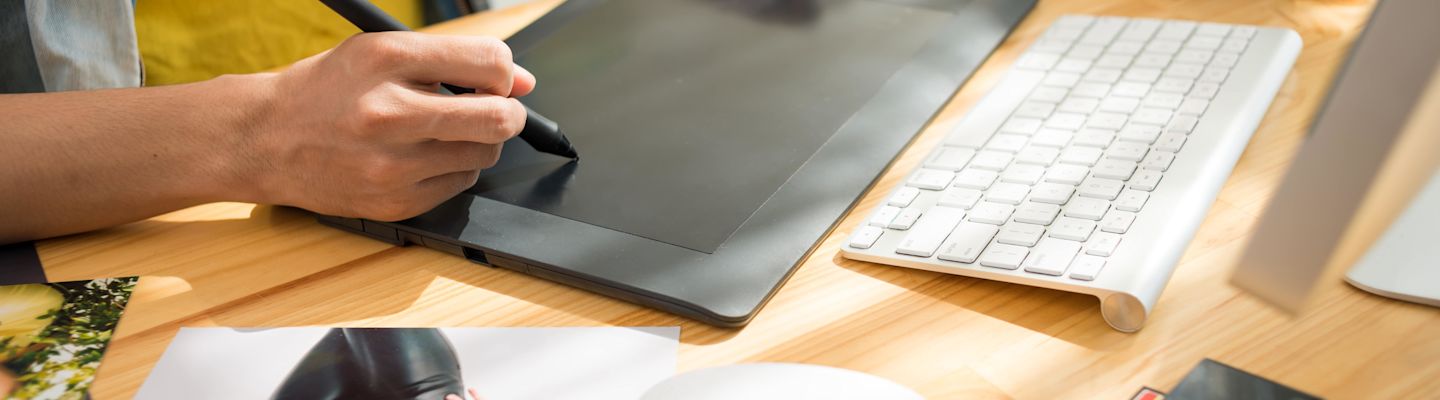 A graphic design student using a graphic device