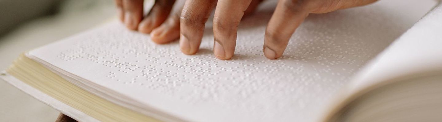 A student reading a braille