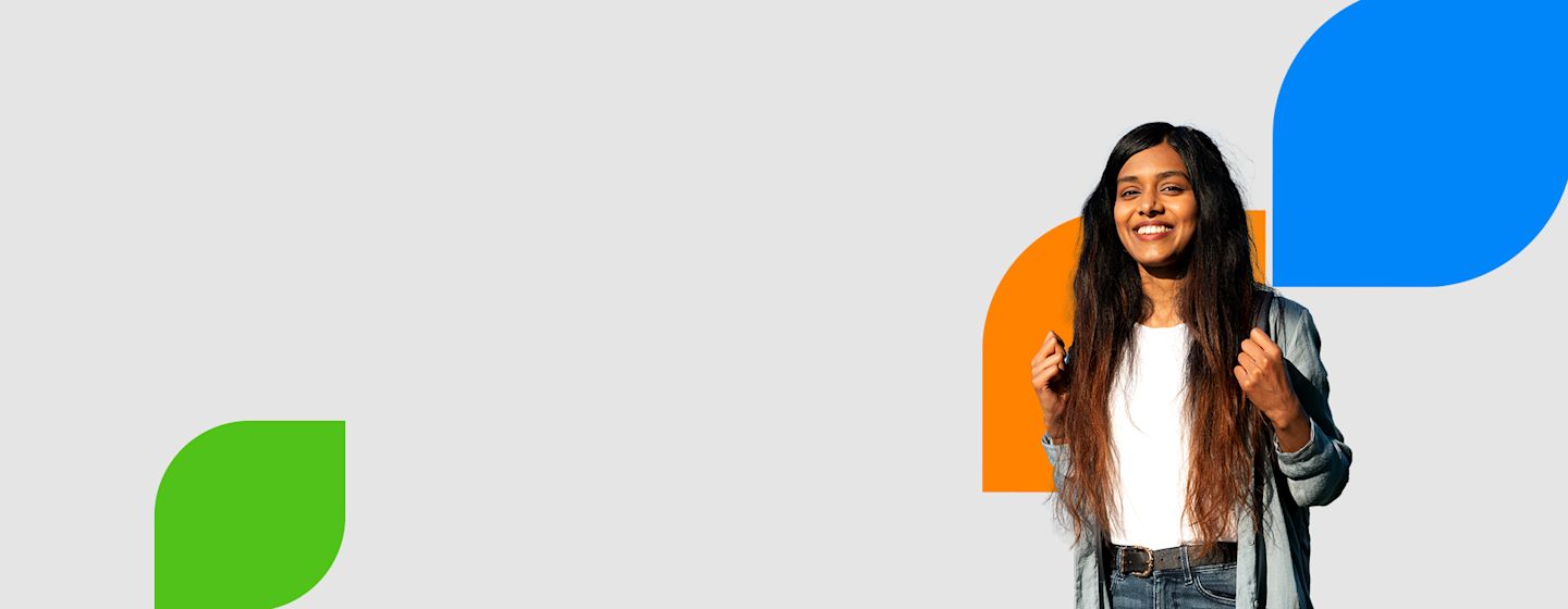 A person with long, dark hair wearing a denim jacket and white shirt, standing against a light gray background with colorful shapes