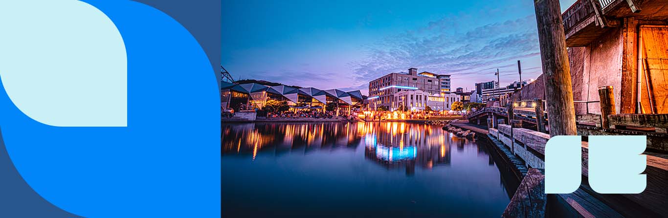  Evening waterfront view of Halifax Seaport Market with illuminated buildings reflecting in calm harbor waters at sunset