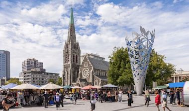 Cityscape of Christchurch with a number of shops and buildings, as people walk leisurely