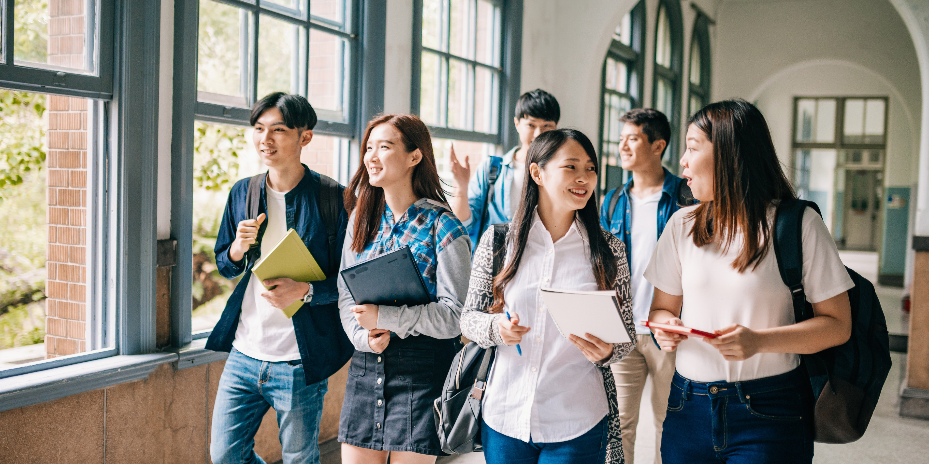 A group of students smiling to each other 