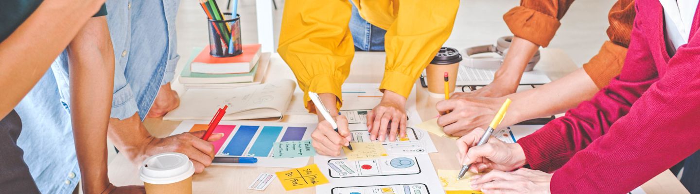 A group of people working on the mobile app design.