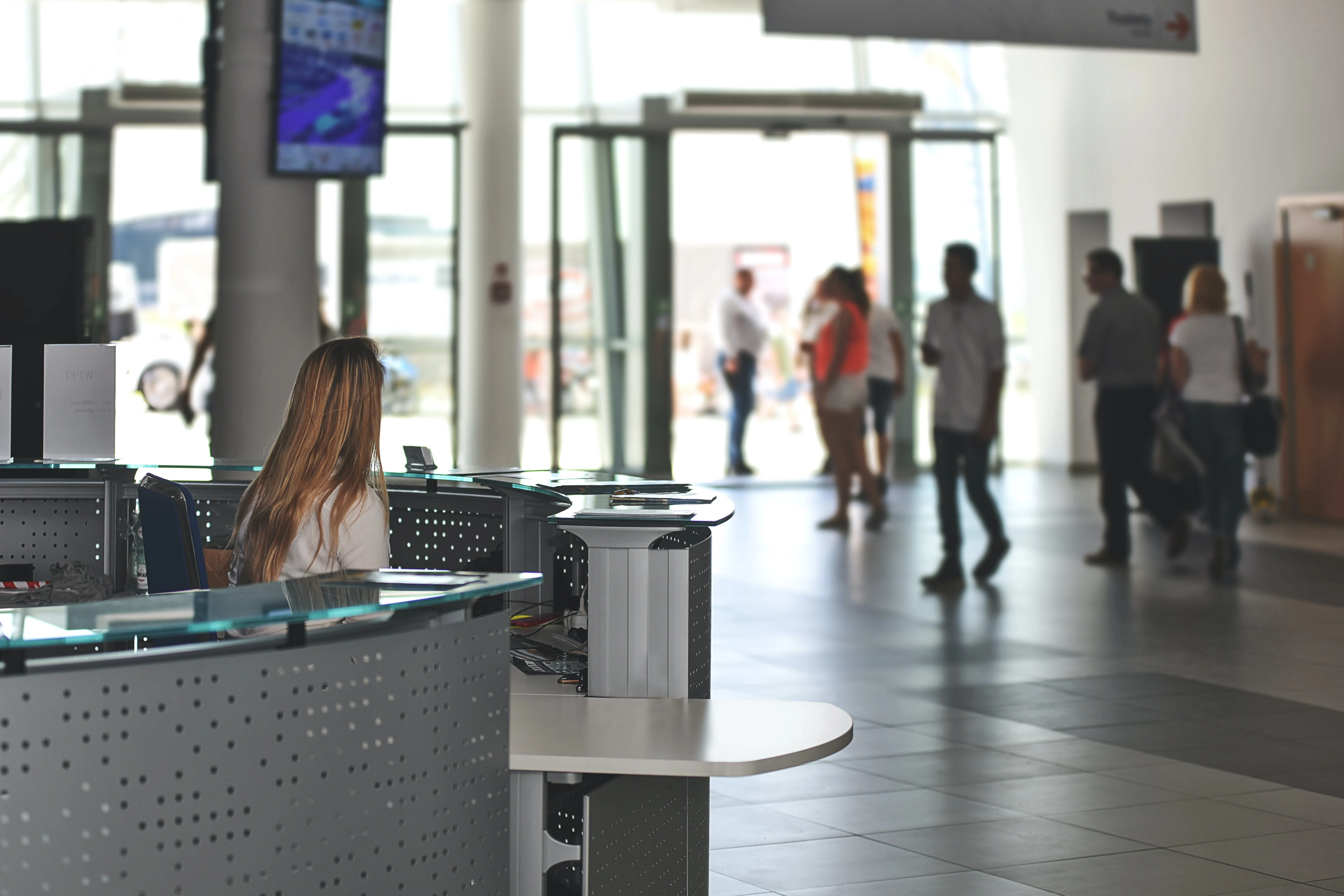 A picture of a girl sitting in the reception at a work place