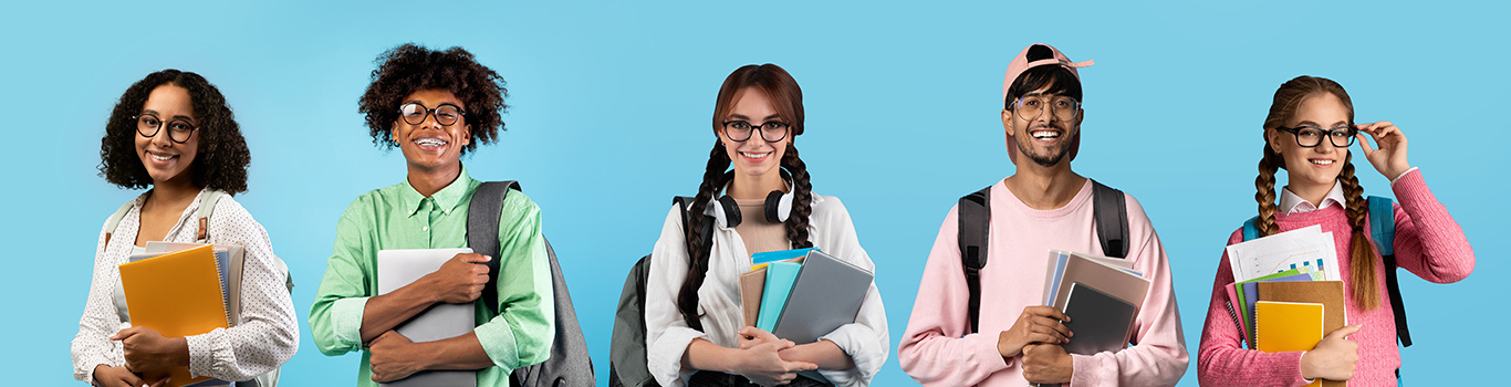 Portraits of happy multiethnic students posing over blue studio backdrop