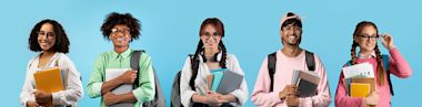 Portraits of happy multiethnic students posing over blue studio backdrop