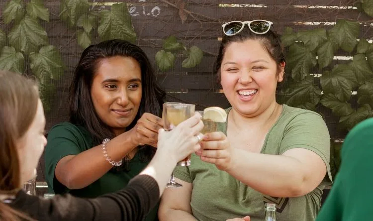 A group of students raising their glasses for a toast at a restaurant