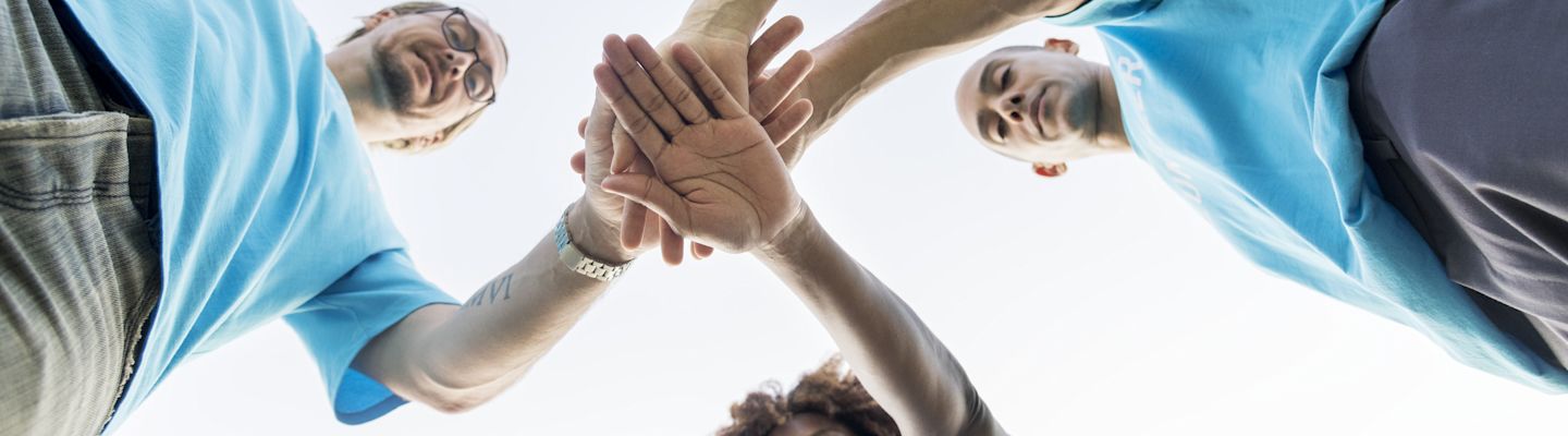 A group of social workers huddle happily