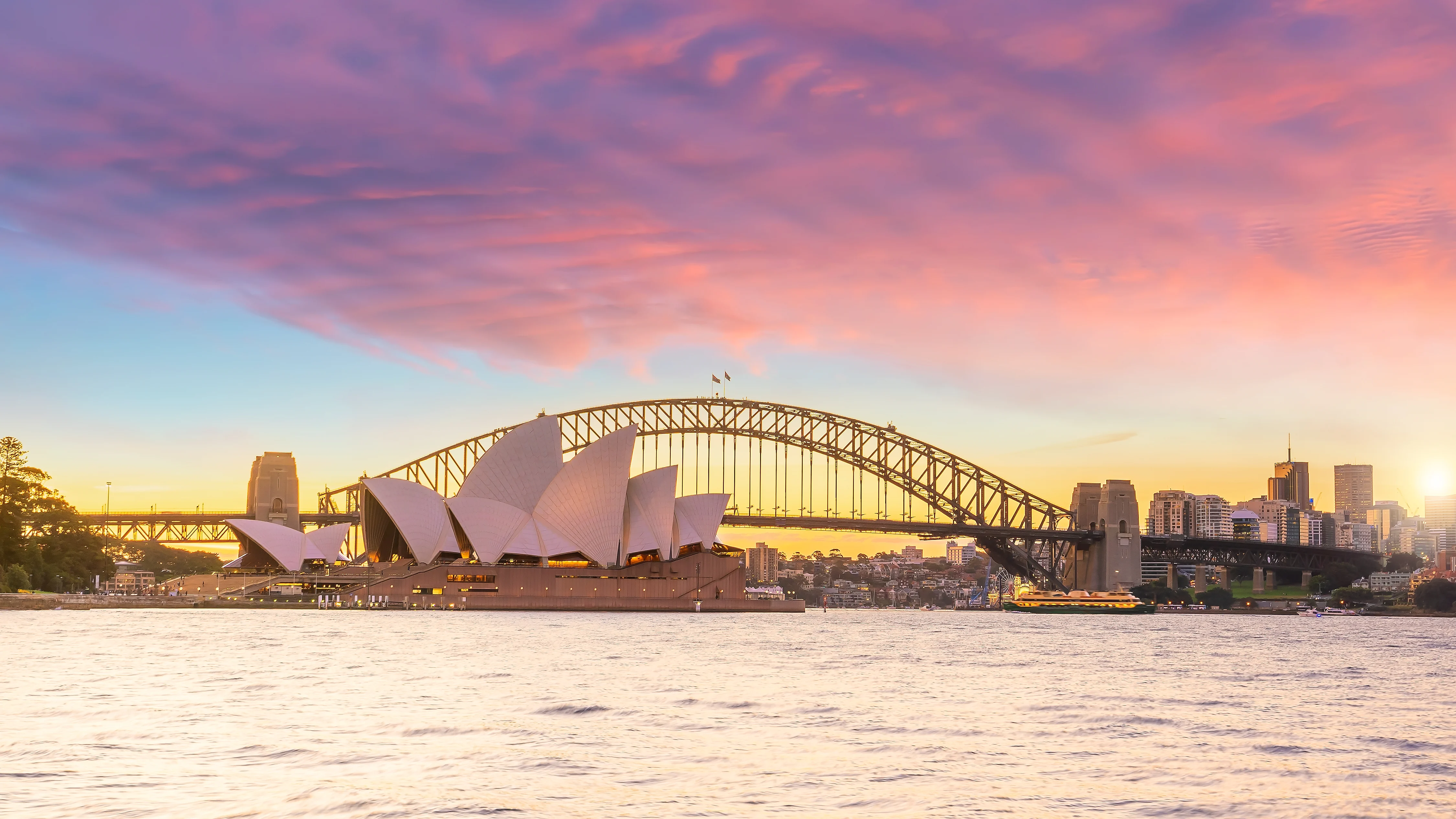 A photograph of the Sydney Opera House along the water's edge