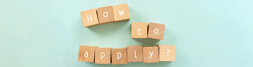 Wooden blocks arranged on a light blue background spell out How to apply? with each word on a separate line.