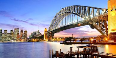 A well lighted bridge in a foreign country 