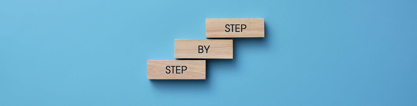 Step by step concept using wooden blocks on a blue background