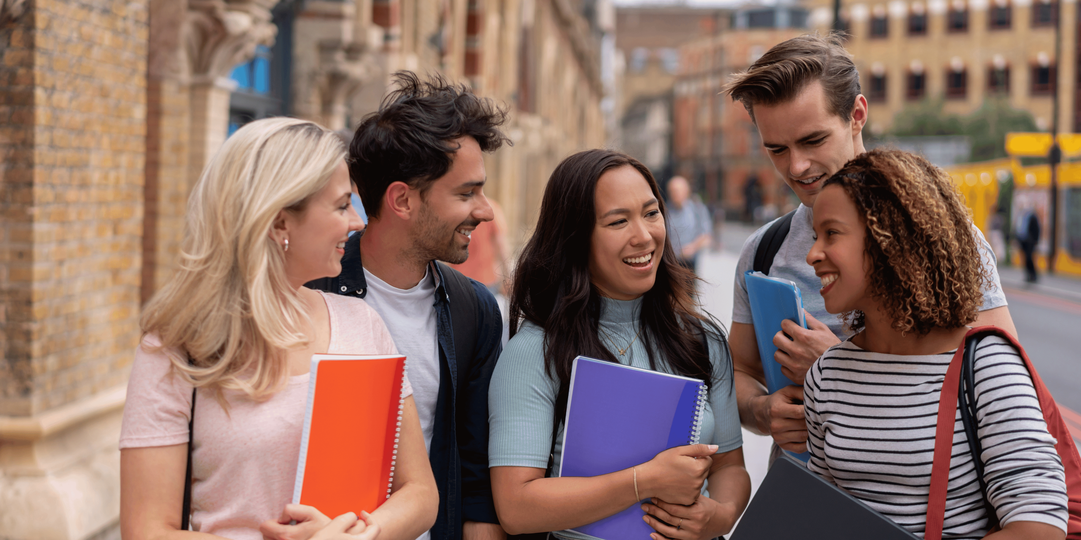 Postgrad students in NZ walking and smiling to each other