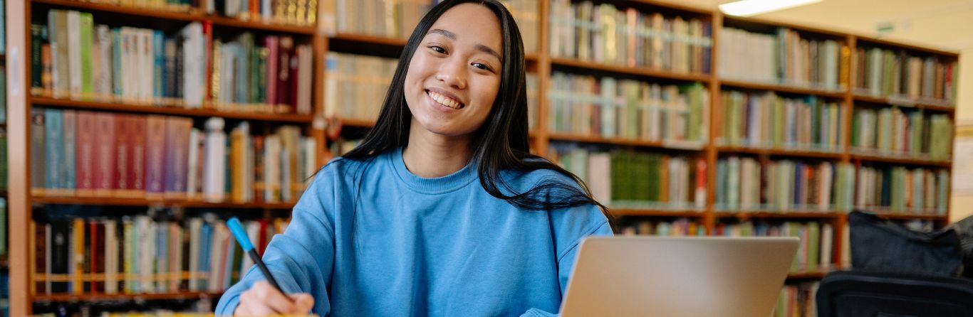 A female foreign student smiling at the camera 