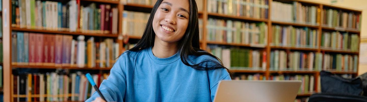 A female foreign student smiling at the camera